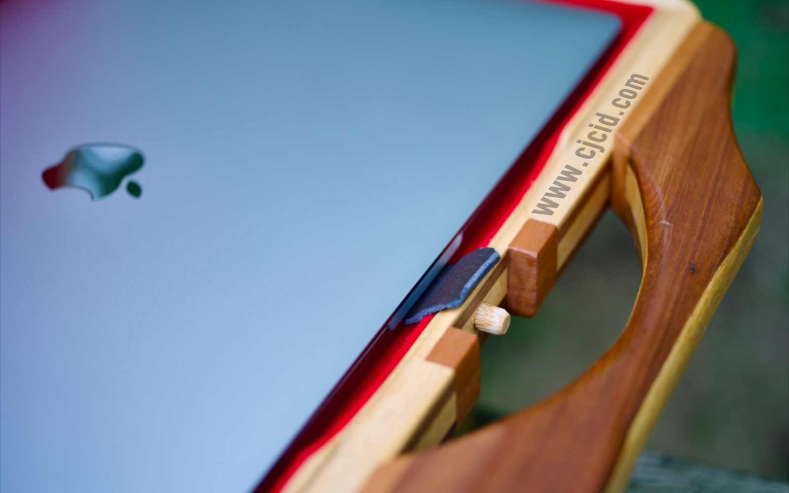 Detail view of the leather tab from inside of the handcrafted solid wood attaché case for the 15″ Apple MacBook Pro