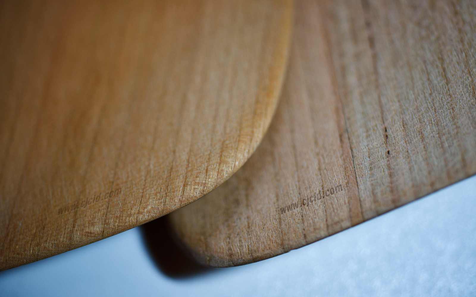 Close up on the tip edges of two cooking spatulæ, made from single block of solid Sakura wood, for right handed usage