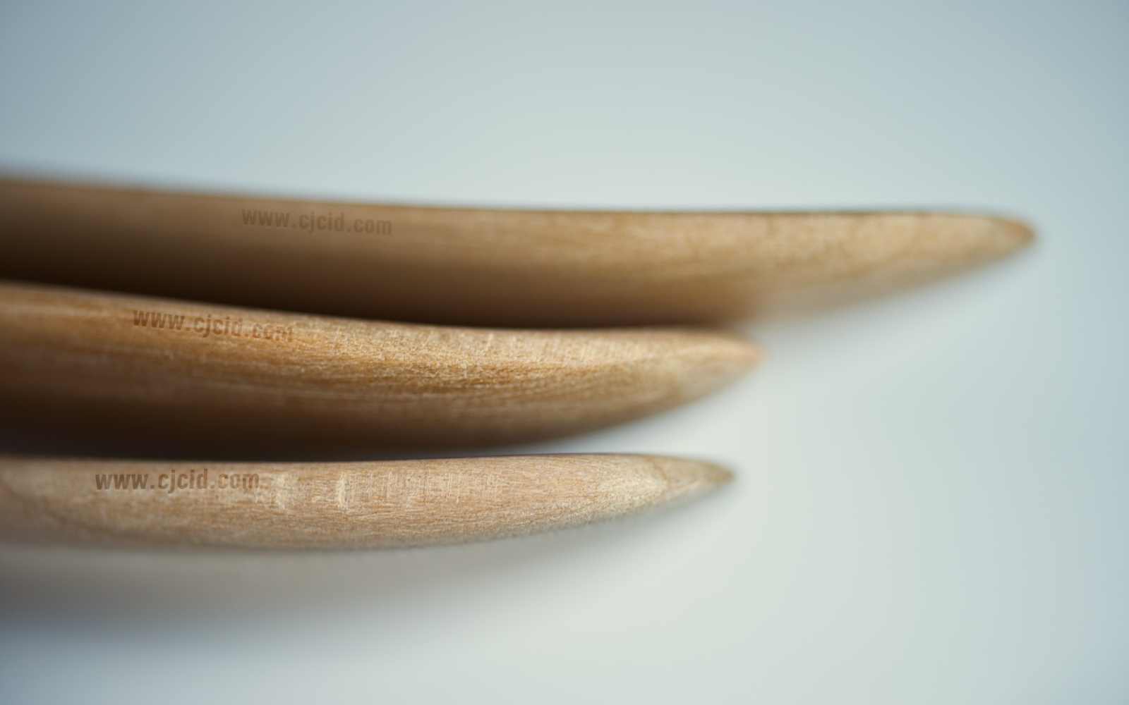 Close up on the tip edges of three cooking spatulæ, made from single block of solid Sakura wood, for right handed usage